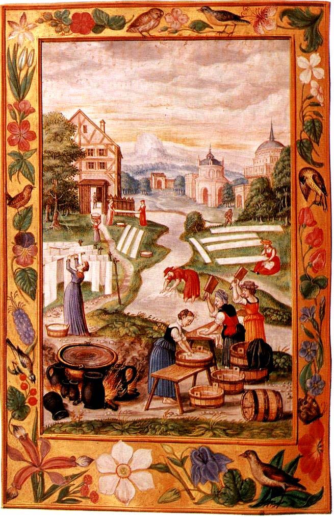 Las mujeres lavando ropa junto al río, con el caldero encendido entre los baldes.